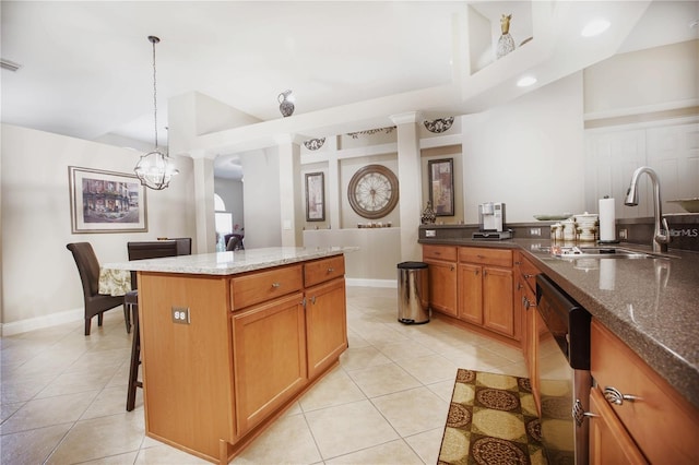 kitchen with pendant lighting, sink, dishwasher, a center island, and light tile patterned flooring