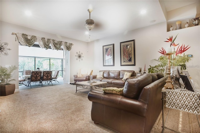 living room with ceiling fan and carpet flooring