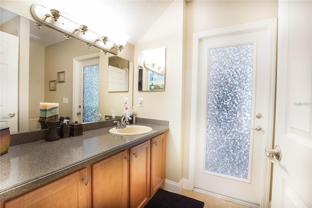 bathroom with vanity and a textured ceiling