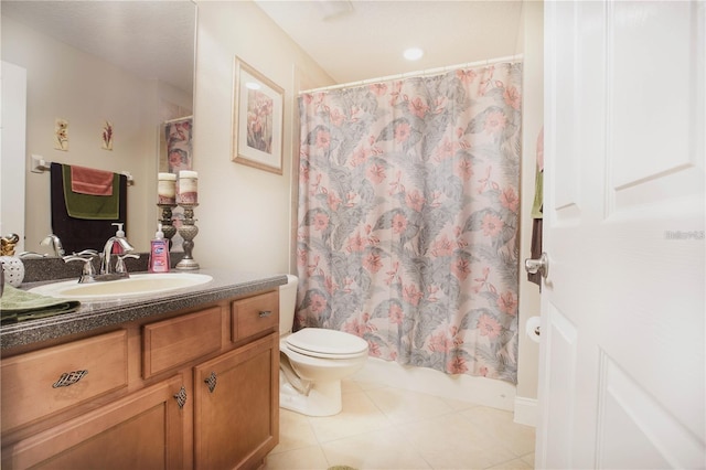 bathroom featuring walk in shower, vanity, toilet, and tile patterned flooring