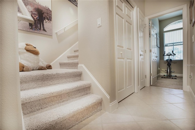 staircase featuring tile patterned floors