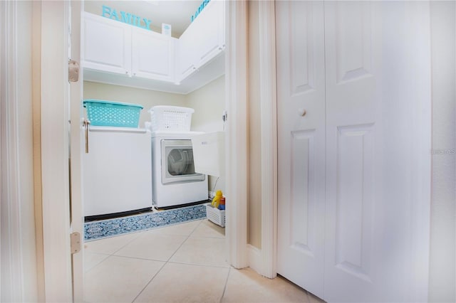 washroom with light tile patterned floors and washing machine and dryer