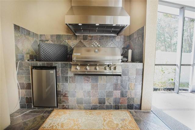 kitchen with stainless steel fridge and extractor fan