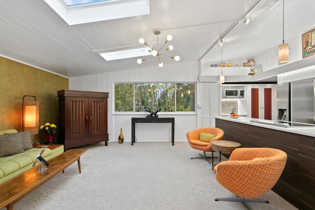 interior space with track lighting, lofted ceiling with skylight, light carpet, and a notable chandelier