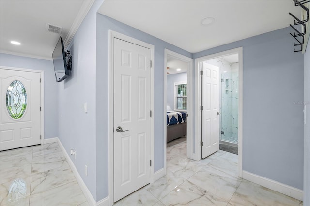 entryway featuring crown molding