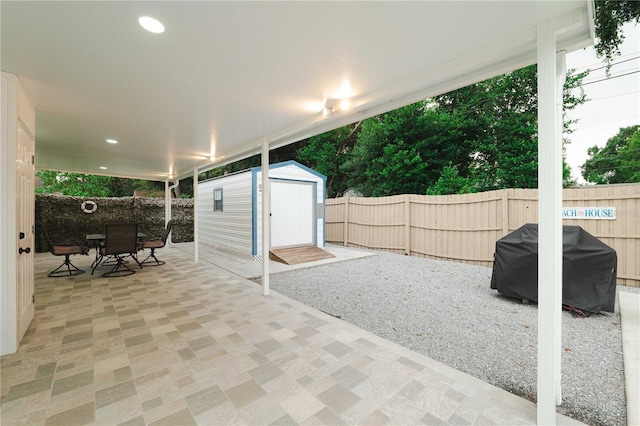 view of patio / terrace featuring a grill and a shed