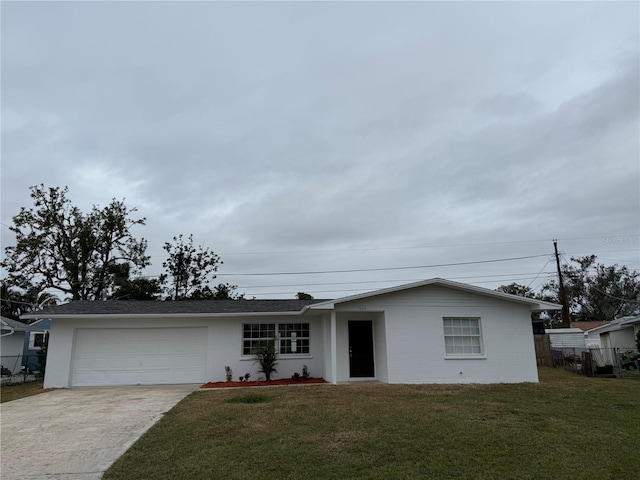 single story home featuring a garage and a front lawn