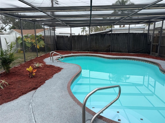 view of pool with glass enclosure