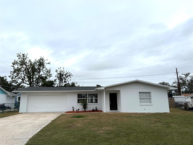 single story home with a garage and a front lawn