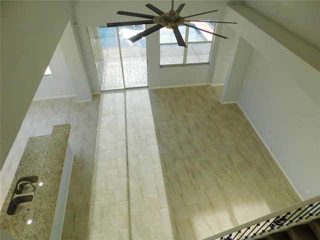 interior space with sink, light hardwood / wood-style flooring, and ceiling fan