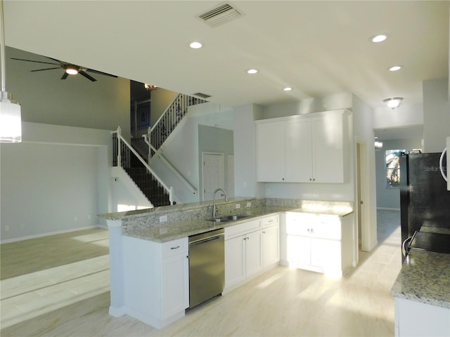 kitchen with black refrigerator, white cabinetry, sink, stainless steel dishwasher, and kitchen peninsula