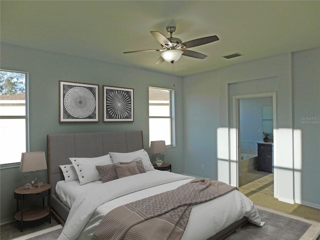 bedroom with light carpet, ceiling fan, and ensuite bathroom