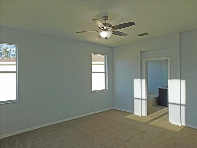 carpeted empty room with ceiling fan