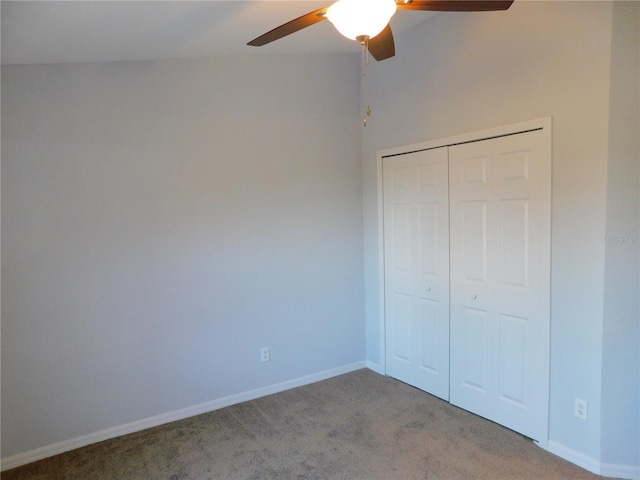 unfurnished bedroom featuring ceiling fan, light colored carpet, and a closet