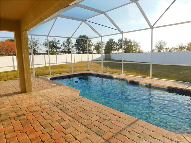 view of pool with a patio area and glass enclosure