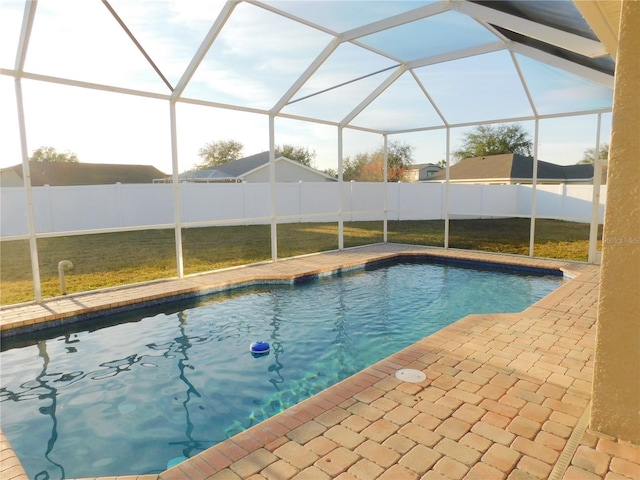 view of pool with a patio and glass enclosure