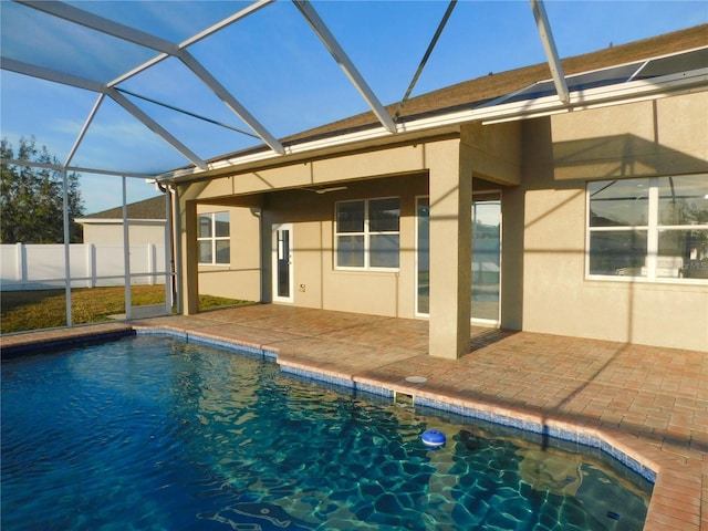 back of house with a fenced in pool, a patio, a lanai, and ceiling fan