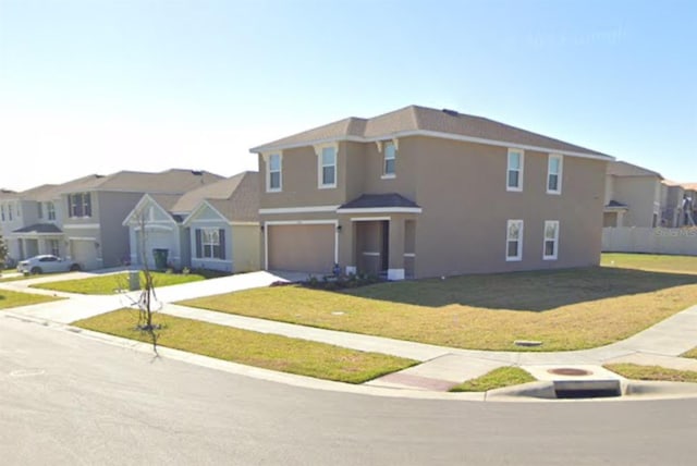 view of front of house with a garage and a front yard