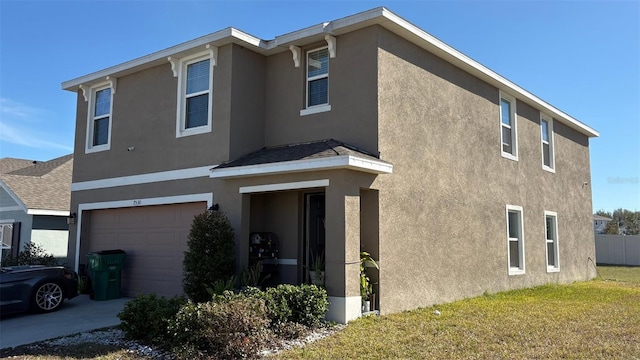 view of front facade with a garage and a front lawn