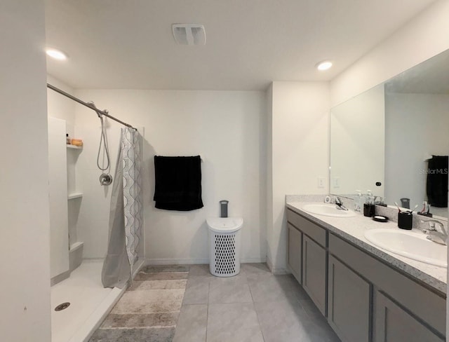 bathroom featuring vanity, tile patterned flooring, and curtained shower