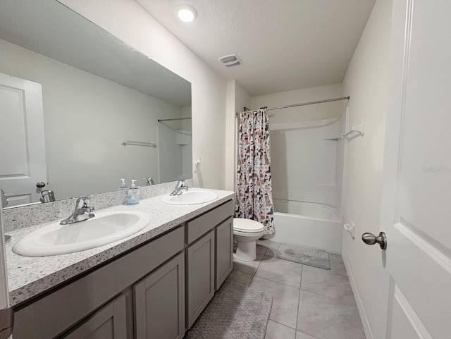 full bathroom featuring shower / bath combo, tile patterned flooring, vanity, a textured ceiling, and toilet