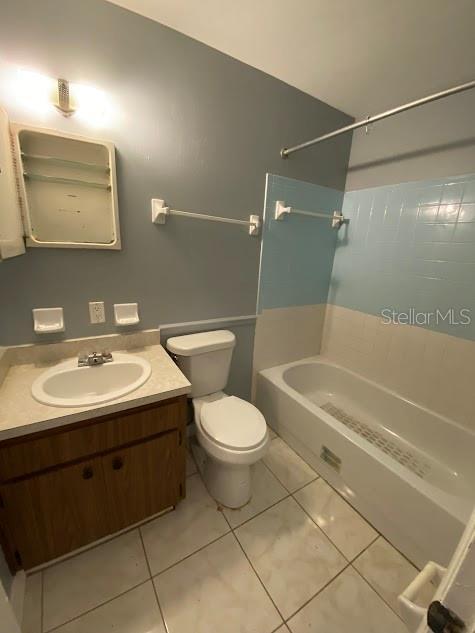 full bathroom with vanity, tile patterned flooring,  shower combination, and toilet