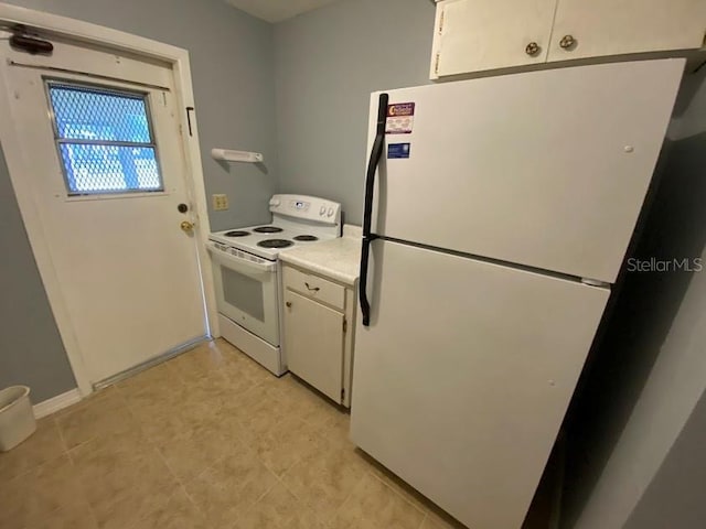 kitchen featuring white appliances and white cabinets