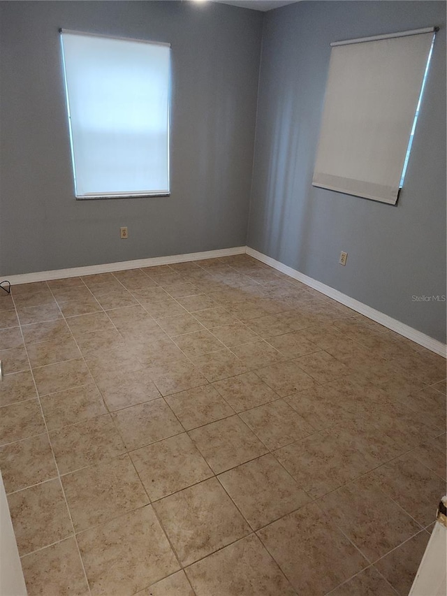 empty room with light tile patterned floors