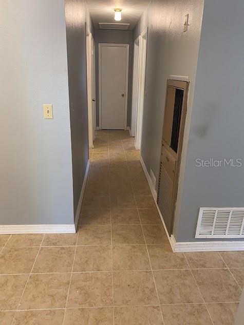 hallway featuring tile patterned flooring