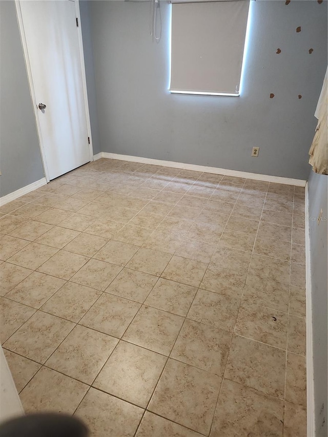 empty room with light tile patterned flooring