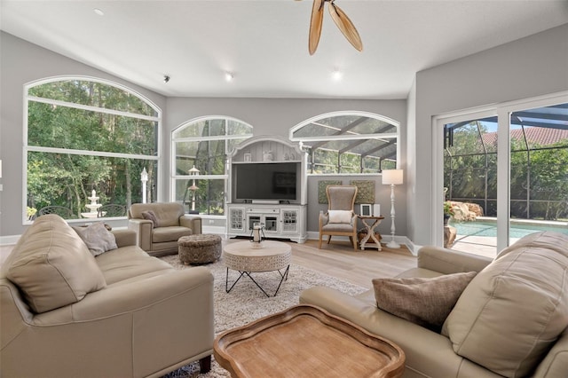 living room featuring wood-type flooring and ceiling fan