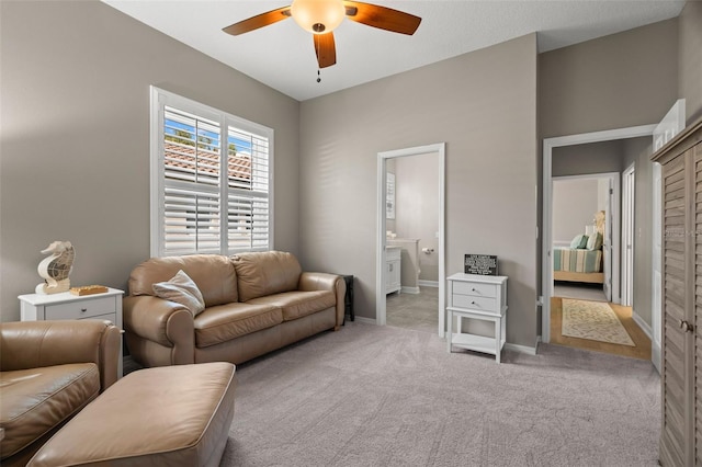 living room featuring light carpet and ceiling fan