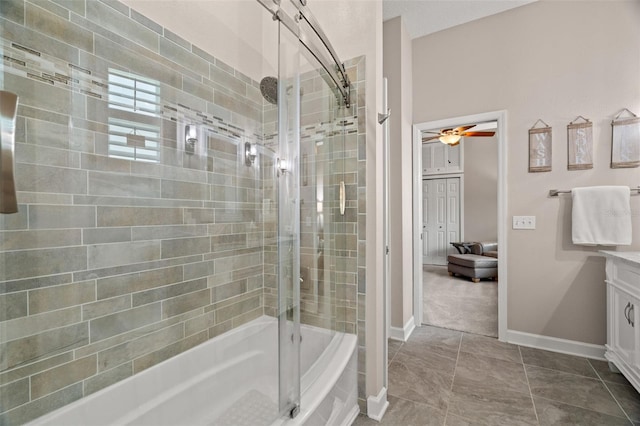 bathroom with ceiling fan, vanity, and bath / shower combo with glass door