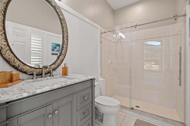 bathroom featuring vanity, toilet, an enclosed shower, and tile patterned flooring