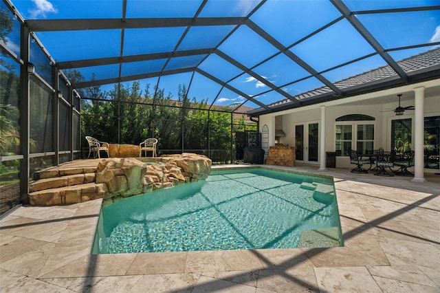 view of pool featuring a lanai, ceiling fan, and a patio area