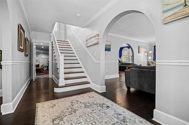 entrance foyer featuring ornamental molding and dark wood-type flooring