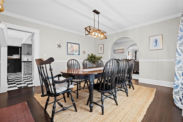 dining space with ornamental molding and hardwood / wood-style floors