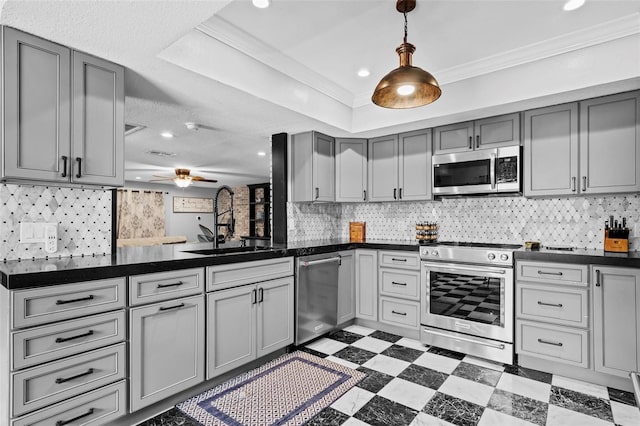 kitchen with sink, tasteful backsplash, ornamental molding, appliances with stainless steel finishes, and gray cabinets