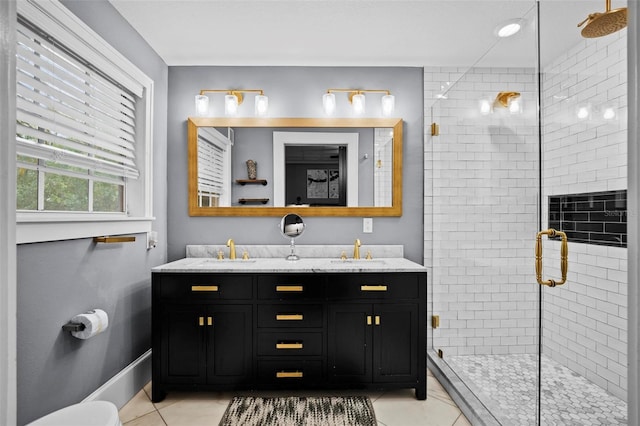 bathroom featuring walk in shower, vanity, and tile patterned flooring