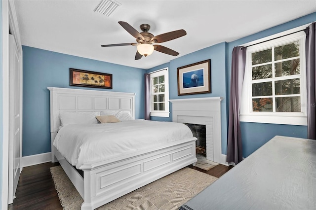 bedroom with ceiling fan and dark hardwood / wood-style flooring