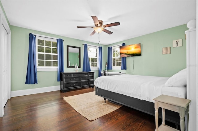 bedroom featuring ceiling fan, dark hardwood / wood-style flooring, and a closet