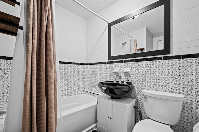 full bathroom with shower / tub combo, tile walls, vanity, tasteful backsplash, and toilet