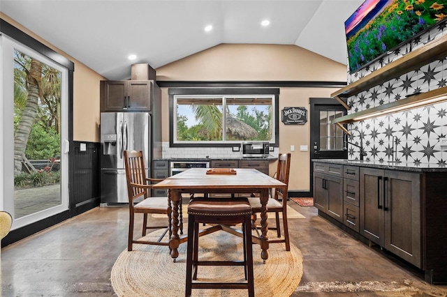 dining space featuring vaulted ceiling