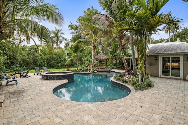 view of pool with an in ground hot tub and a patio area