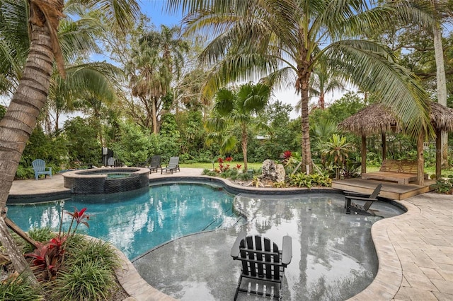 view of pool featuring an in ground hot tub and a patio area