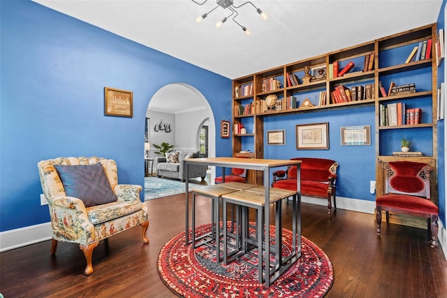 319 26th St W, Bradenton, FL 34205 - living area featuring arched walkways, wood finished floors, a chandelier, and baseboards