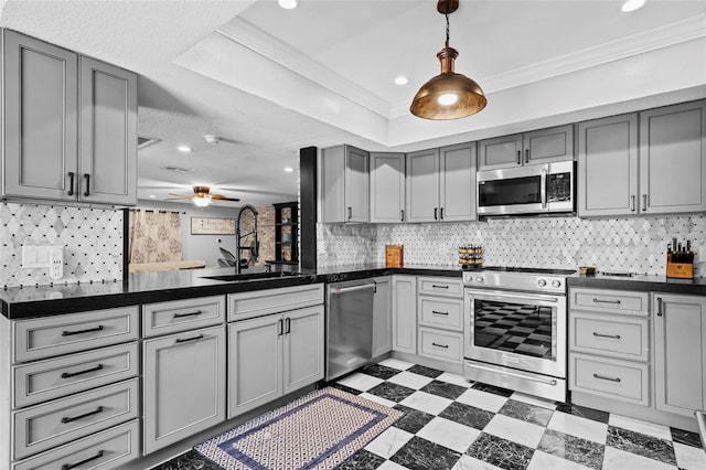 319 26th St W, Bradenton, FL 34205 - kitchen with stainless steel appliances, a sink, gray cabinets, tile patterned floors, and dark countertops