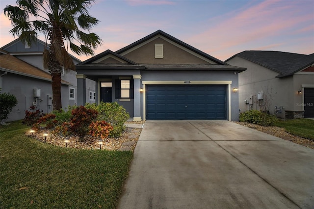 view of front facade with a garage and a yard