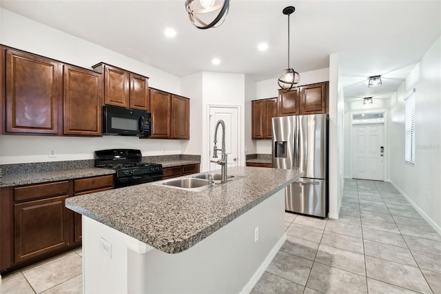 kitchen featuring light tile patterned flooring, sink, a center island with sink, and black appliances