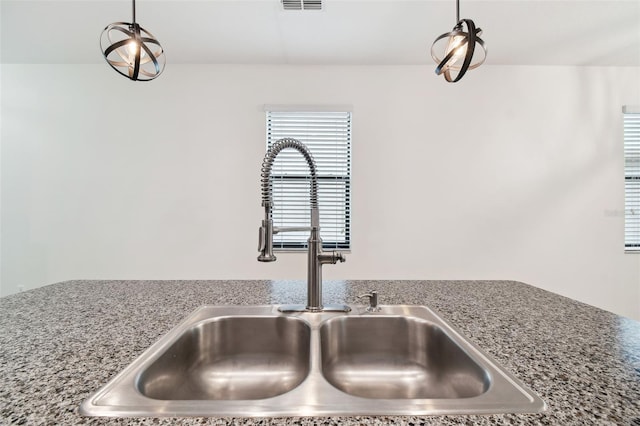 interior details with sink and decorative light fixtures